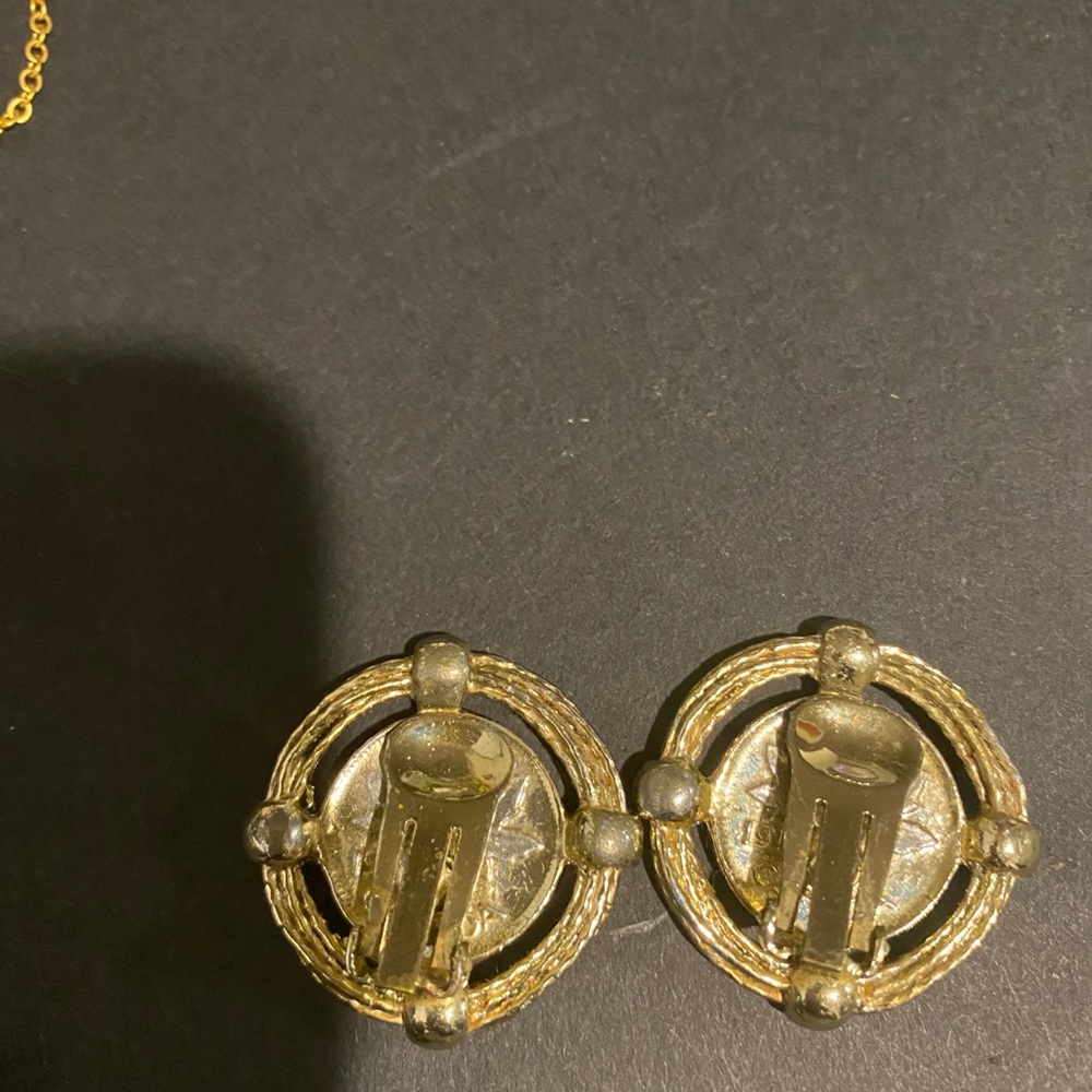 Gold tone clip on Greek coin earrings.